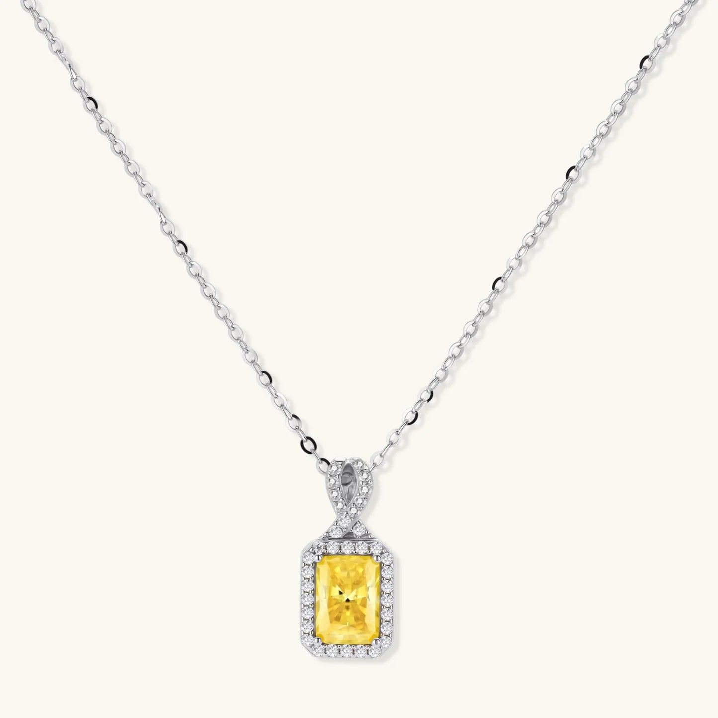 Yellow moissanite jewelry set with emerald-cut stones in sterling silver halo settings.