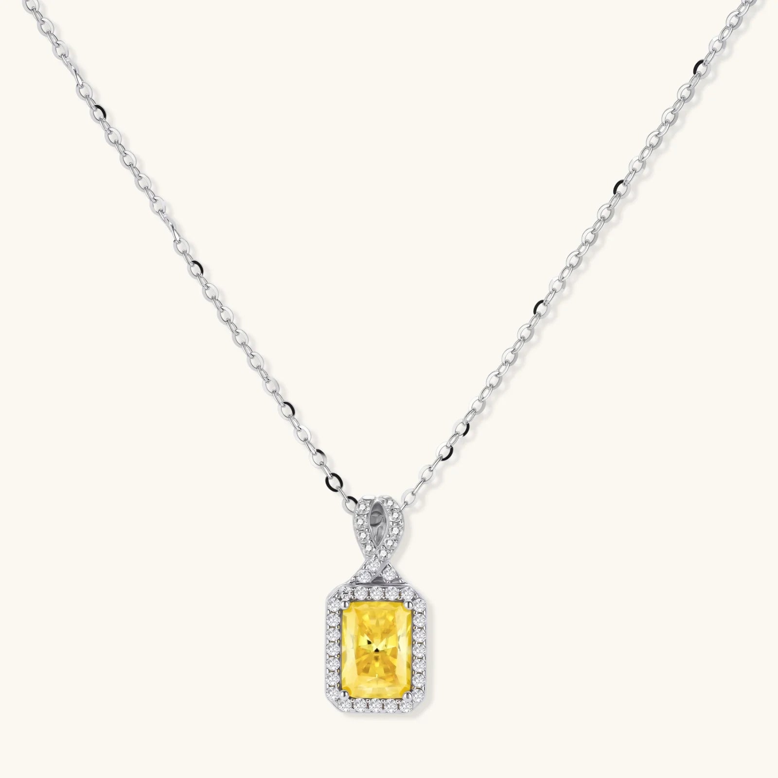 Yellow moissanite jewelry set with emerald-cut stones in sterling silver halo settings.