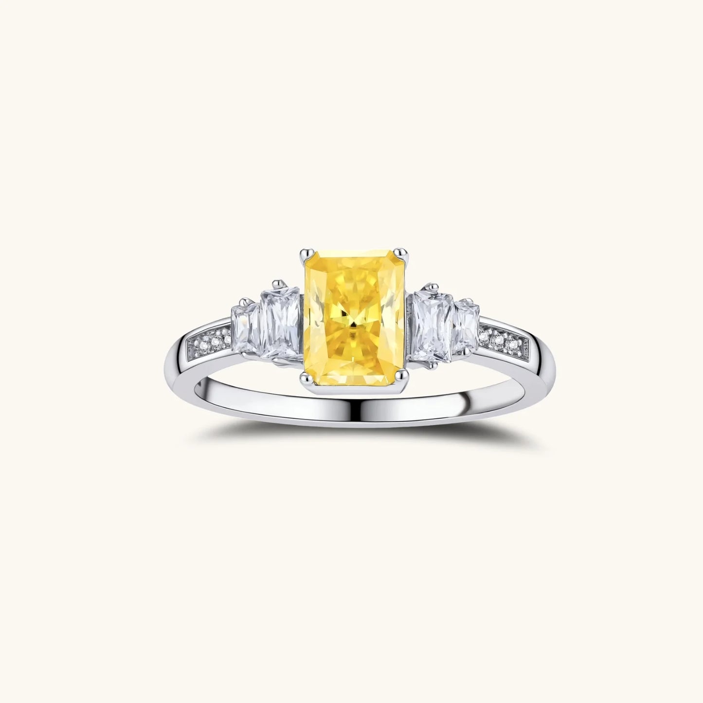 Yellow moissanite jewelry set with emerald-cut stones in sterling silver halo settings,