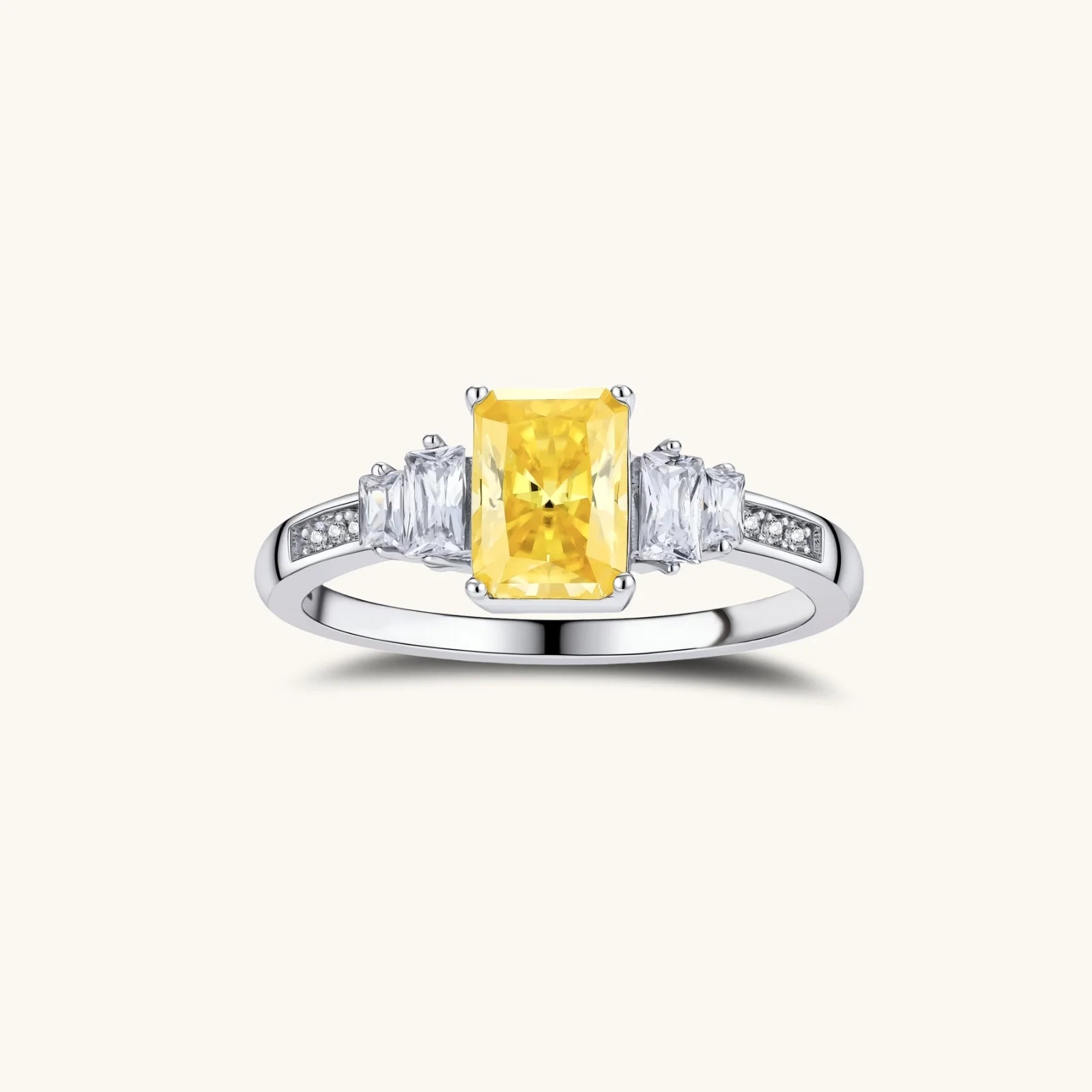Yellow moissanite jewelry set with emerald-cut stones in sterling silver halo settings,